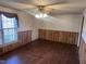 Living room with wood-look floors and wood paneling at 201 Providence Rd, Oxford, NC 27565