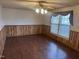 Living room with wood-look floors and wood paneling at 201 Providence Rd, Oxford, NC 27565