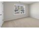 Bright bedroom featuring a large window and carpeted floor at 2557 Summersby Dr, Mebane, NC 27302