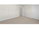 Simple, carpeted bedroom with an open door to another room at 2557 Summersby Dr, Mebane, NC 27302