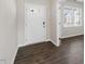 Front entry with white door, wood-look floors, and access to other rooms at 2557 Summersby Dr, Mebane, NC 27302