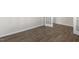 Wood-look floor in an office with white baseboards and French doors at 2557 Summersby Dr, Mebane, NC 27302