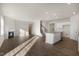 Open floor plan boasts a kitchen island, stainless steel appliances, and a cozy fireplace at 2557 Summersby Dr, Mebane, NC 27302