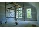 Attic space with natural light through large windows, scaffolding, and unfinished walls at 301 W College St, Louisburg, NC 27549