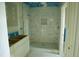 New bathroom featuring a tiled shower with niche and neutral vanity at 301 W College St, Louisburg, NC 27549