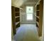 Walk-in closet with shelving and a window for natural light at 301 W College St, Louisburg, NC 27549