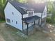 Stunning two-story home showcasing a white exterior with black accents and a brick-lined garage at 301 W College St, Louisburg, NC 27549