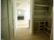 Hallway view showcasing hardwood floors, storage space, and an unfinished kitchen in the background at 301 W College St, Louisburg, NC 27549