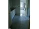 View through hallway to bedroom with bright windows, and ladder, and white cabinets at 301 W College St, Louisburg, NC 27549