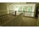 The upstairs landing with wood floors and metal railing, looking out over the great room at 301 W College St, Louisburg, NC 27549