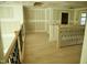 The upstairs landing with wood floors and metal railing, looking out over the great room at 301 W College St, Louisburg, NC 27549