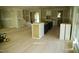 Bright, unfinished kitchen area with hardwood floors, a large window, and a black center island at 301 W College St, Louisburg, NC 27549