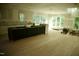Spacious, unfinished kitchen featuring ample natural light, black island base, and hardwood flooring at 301 W College St, Louisburg, NC 27549