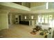 Expansive, unfinished living room with hardwood flooring, large windows, and space for a kitchen at 301 W College St, Louisburg, NC 27549