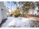 Fenced backyard with mature trees and winter snow at 507 Price Ave, Durham, NC 27701