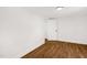 Well-lit bedroom with hardwood floors and an open door at 507 Price Ave, Durham, NC 27701