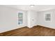 Bright bedroom with hardwood floors and two windows at 507 Price Ave, Durham, NC 27701