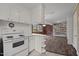 Kitchen with white appliances and view of dining area at 515 W Cardinal St, Siler City, NC 27344