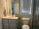 This bathroom features modern cabinets, a window, and a tile shower at 54 Cottage Way Way, Pittsboro, NC 27312
