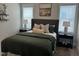 This bedroom features two windows, neutral walls, and a decorative headboard at 54 Cottage Way Way, Pittsboro, NC 27312