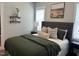 This bedroom features a gray headboard, a window, decorative shelving, and modern decor at 54 Cottage Way Way, Pittsboro, NC 27312