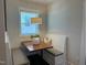 Charming breakfast nook with a cozy built-in bench and a window that fills the area with natural light at 54 Cottage Way Way, Pittsboro, NC 27312