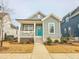 Gray craftsman style home with a teal door and white porch at 54 Cottage Way Way, Pittsboro, NC 27312