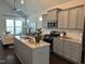 Modern kitchen with stainless steel appliances, granite countertops, and an island offering ample workspace at 54 Cottage Way Way, Pittsboro, NC 27312