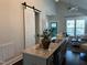 Open kitchen with a granite island sink is steps away from a stylish living area for easy gathering at 54 Cottage Way Way, Pittsboro, NC 27312