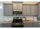 Well-equipped kitchen with stainless steel appliances, light gray cabinets, and modern finishes providing ample counter space at 54 Cottage Way Way, Pittsboro, NC 27312
