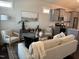 Bright living room with modern decor flows into the kitchen, creating an open and inviting atmosphere at 54 Cottage Way Way, Pittsboro, NC 27312