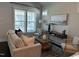 Sun-filled living room showcasing neutral tones, large windows, and comfortable seating, perfect for relaxation at 54 Cottage Way Way, Pittsboro, NC 27312