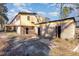 Back of house with detached garage and overgrown yard at 602 E Club Blvd, Durham, NC 27704