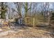 Small yellow shed with debris in the surrounding area at 602 E Club Blvd, Durham, NC 27704