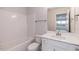 This bathroom features a tub and shower combo, white vanity, and a large mirror at 62 Faircox Way # 139, Garner, NC 27529
