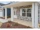 Charming front porch with stone accents, white columns, and a stylish front door at 62 Faircox Way # 139, Garner, NC 27529