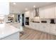 Bright kitchen featuring white cabinetry, stainless steel range hood, and a breakfast bar at 62 Faircox Way # 139, Garner, NC 27529