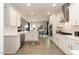 Modern kitchen with white cabinets, island, and open layout to the dining area at 62 Faircox Way # 139, Garner, NC 27529
