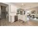 Open-concept kitchen featuring white cabinets, quartz countertops, and stainless steel appliances at 62 Faircox Way # 139, Garner, NC 27529