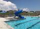 Community pool with a slide and several lounge chairs overlooking neighborhood homes at 62 Faircox Way # 139, Garner, NC 27529