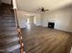 Spacious living room with fireplace, ceiling fan, and wood-look floors at 65 Barony Ln, Smithfield, NC 27577