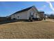 Side view of tan house with bushes at 670 Meadowtop Cir, Burlington, NC 27217