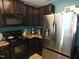 Kitchen with stainless steel appliances and dark cabinets at 670 Meadowtop Cir, Burlington, NC 27217
