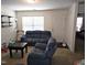 Living room with blue reclining sofas and a coffee table at 670 Meadowtop Cir, Burlington, NC 27217