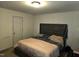 Main bedroom with a large bed and tufted headboard at 670 Meadowtop Cir, Burlington, NC 27217