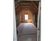 Unfinished attic space featuring exposed beams, natural light, and subflooring at 71 Priming Way, Angier, NC 27501