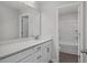 Bathroom with white double vanity featuring quartz countertop and large mirror at 71 Priming Way, Angier, NC 27501