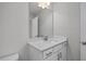 A modern bathroom vanity featuring quartz countertop, white cabinets, and a large mirror at 71 Priming Way, Angier, NC 27501