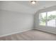 A bright bedroom with vaulted ceilings and a large window providing an exterior view at 71 Priming Way, Angier, NC 27501