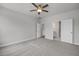 Large bedroom with ceiling fan and two door frames leading to other rooms in the house at 71 Priming Way, Angier, NC 27501